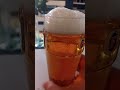 Pouring a can of Fosters into a Fosters pint glass