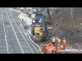 Construction along tracks CN Hamilton - rail on fire, little person worker moving heavy load