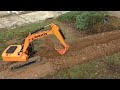 RC excavator digging a long trench for some scale storm water pipes