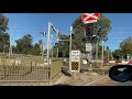 Pacific National freight train travels through Torrens road railway crossing at Ovingham