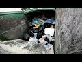 Waste Management front load garbage truck packing garbage