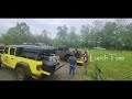 Wet Jeep Gladiators on a Muddy Trail