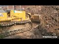 Great job, KOMATSU D31P pouring soil to prevent the house from collapsing