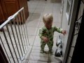 Baby boy chases dachshund dog in circles