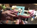 Smoothing a candle wax model before casting in bronze using lost wax method