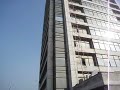 man scrubbing building in Dhaka