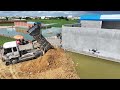 Interesting Dozer & Truck Pouring soil behind villagers' houses, surrounded by flooded water