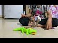So adorable smart baby monkey Avatar playing with crocodile toy