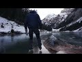 lonely ice skating on a black frozen mountain lake / slow tv nature