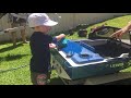 Two year old drives his own mini petrol powered speed boat.