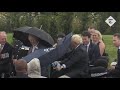 Boris Johnson struggles with umbrella at police memorial unveiling