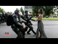 See Powerful Image of Woman Wearing Dress While Facing Police During Protest