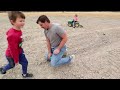 Using kids tractors to plow up hidden toys in dirt | Tractors for kids