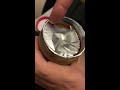 Tearing the aluminum top from peanut butter tub