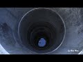 Install circular concrete pipes into the well using a manual winch - for cleaner well water