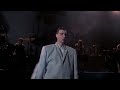 David Byrne dancing in a big suit