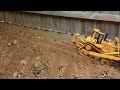 RC Dozer pushing dirt on dangerous road