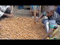 Beating Tamarind Outside the Farmer's Market in Mbale, Uganda