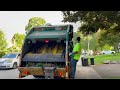 WM Garbage Truck Packing A Masive Yard Waste Pile