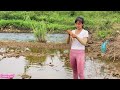 Girl harvests giant fish by the stream using a vacuum cleaner \ country girl