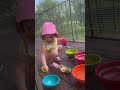 Lillia playing with water bowls
