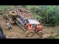 The tractor overturned while carrying wood downhill in the rain