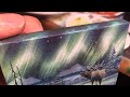 Watercolor painting of an elk on a miniature canvas.