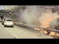 Terrifying moment a man is saved from a burning car after group of Good Samaritans rush to his aid