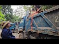 female driver Driving a truck alone carrying onions in the city to the village.