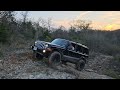 2005 jeep hemi commander on 35's playing rock bouncer.