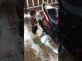 little boy washing motorbike