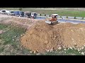 So Many Dump Trucks Waiting To Loading Soil Filling a Big Land With Small Bulldozer