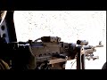 chinook door gunner fires his machine gun