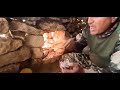 Building a stone shelter with a fireplace before it rains | Survival in nature