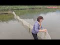 Baiting fish into a trap, the girl uses a net to dredge the fish.