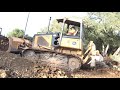 John Deere 650j bulldozer pushing clay