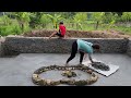 Mother and daughter poured the bottom of a fish pond into a flower bed