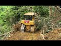 Great idea! CAT D6r XL bulldozer makes a terrace on the edge of a mountain cliff