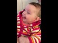 Baby girl getting ears pierced giggling away